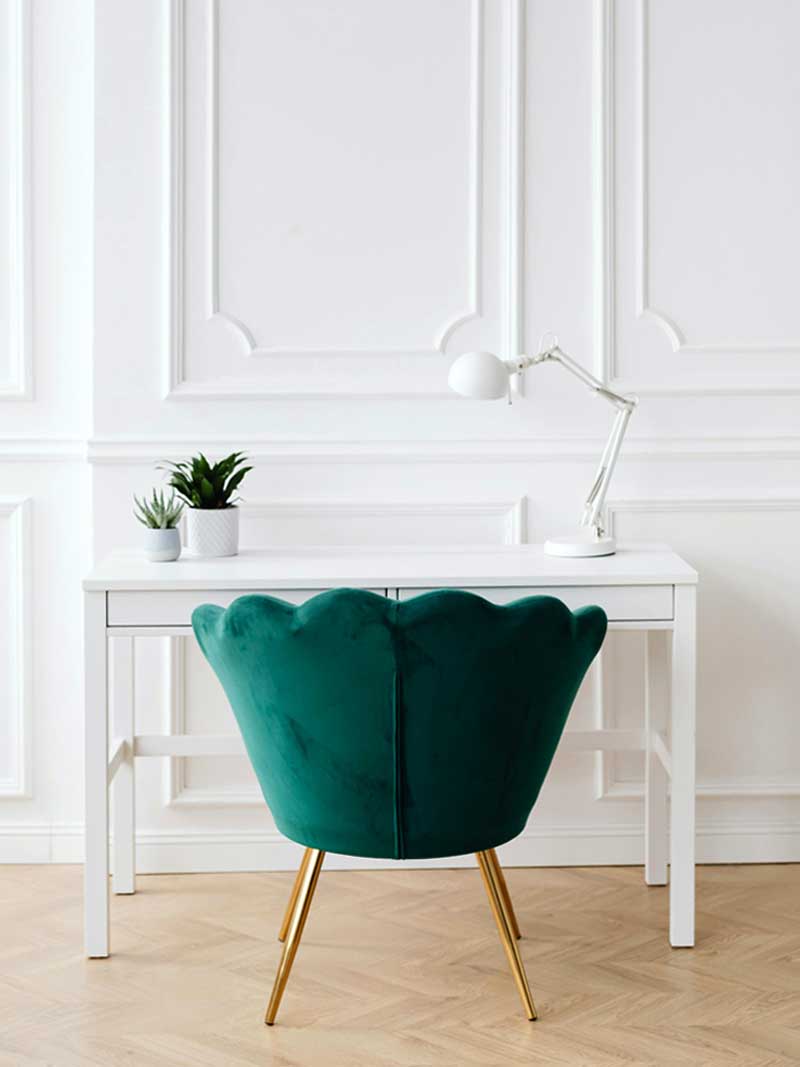 White walls with desk and green chair